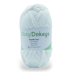 A skein of white chenille yarn labeled Okey Dokeys Chenille Yarn with details of 100% Polyester, 100g, and 3.52 oz. marshmallow fluff white super bulky