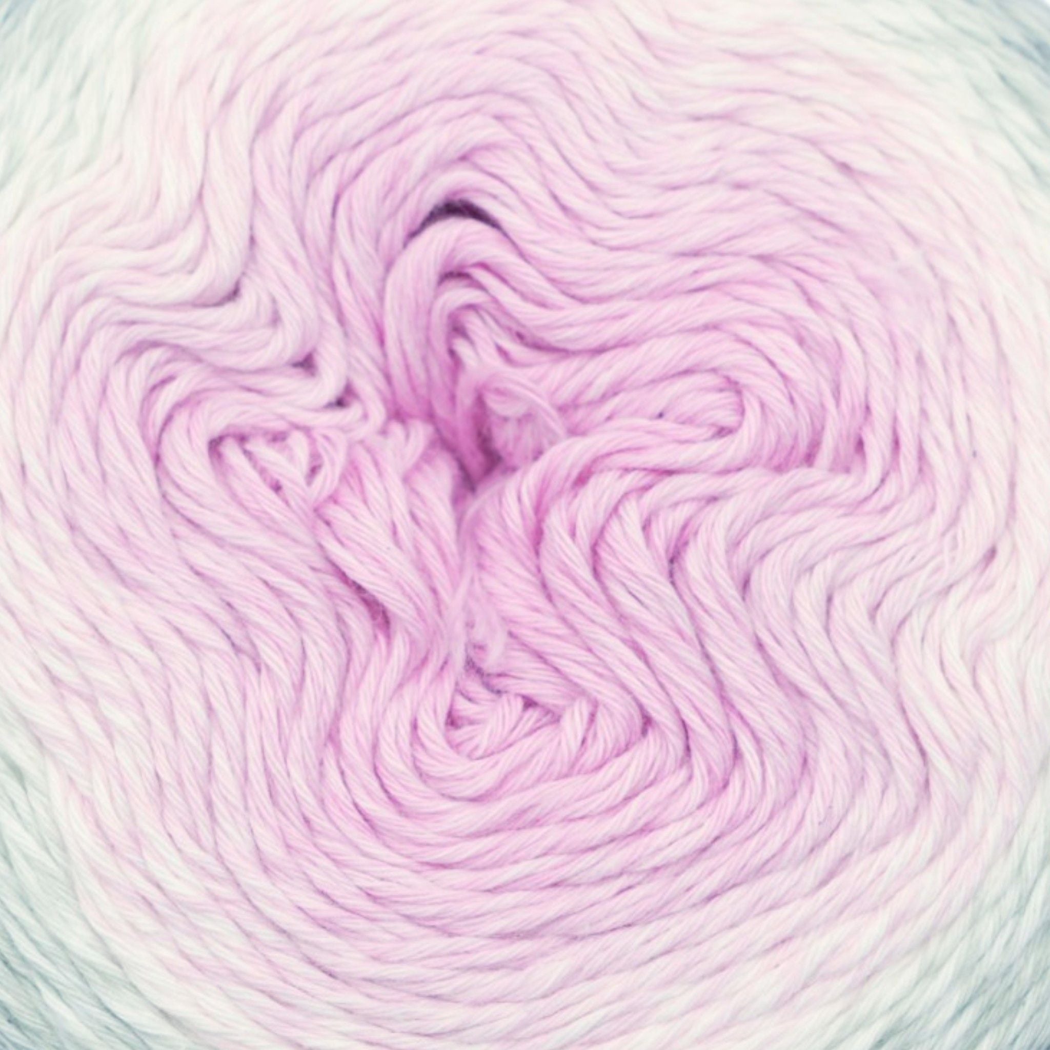 Close-up of pink and purple yarn with a gradient effect.