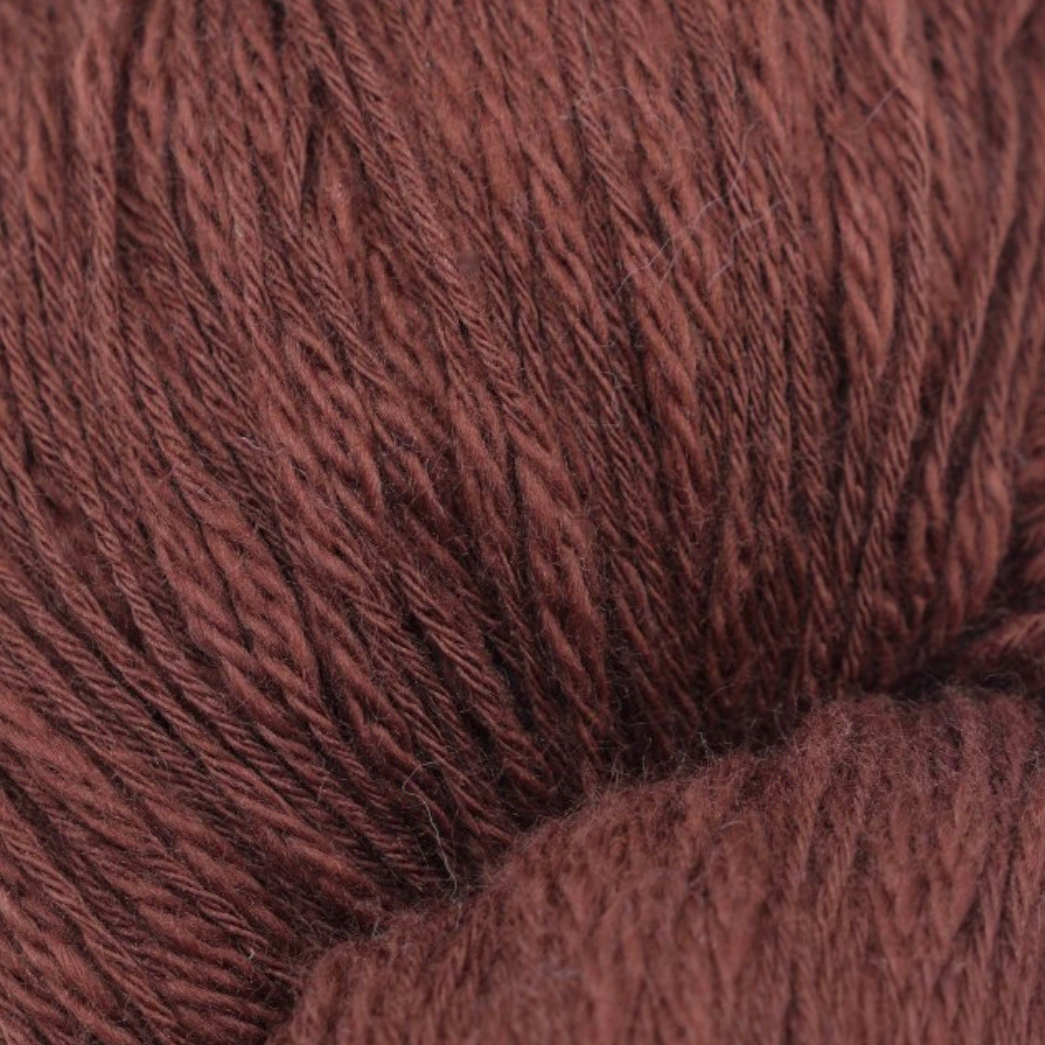 A skein of dark brown cotton slub yarn.