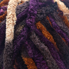 Multicolored skein of yarn with Okey Dokeys label on a white background space dye close up