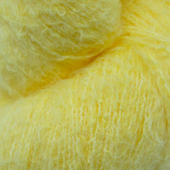 A skein of fuzzy lace yarn in a light yellow color, displayed against a plain background.