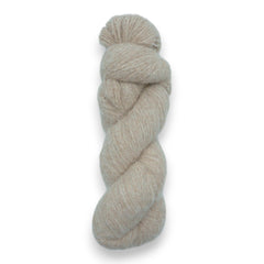 A skein of fuzzy lace yarn in a light brown color, displayed against a plain background.