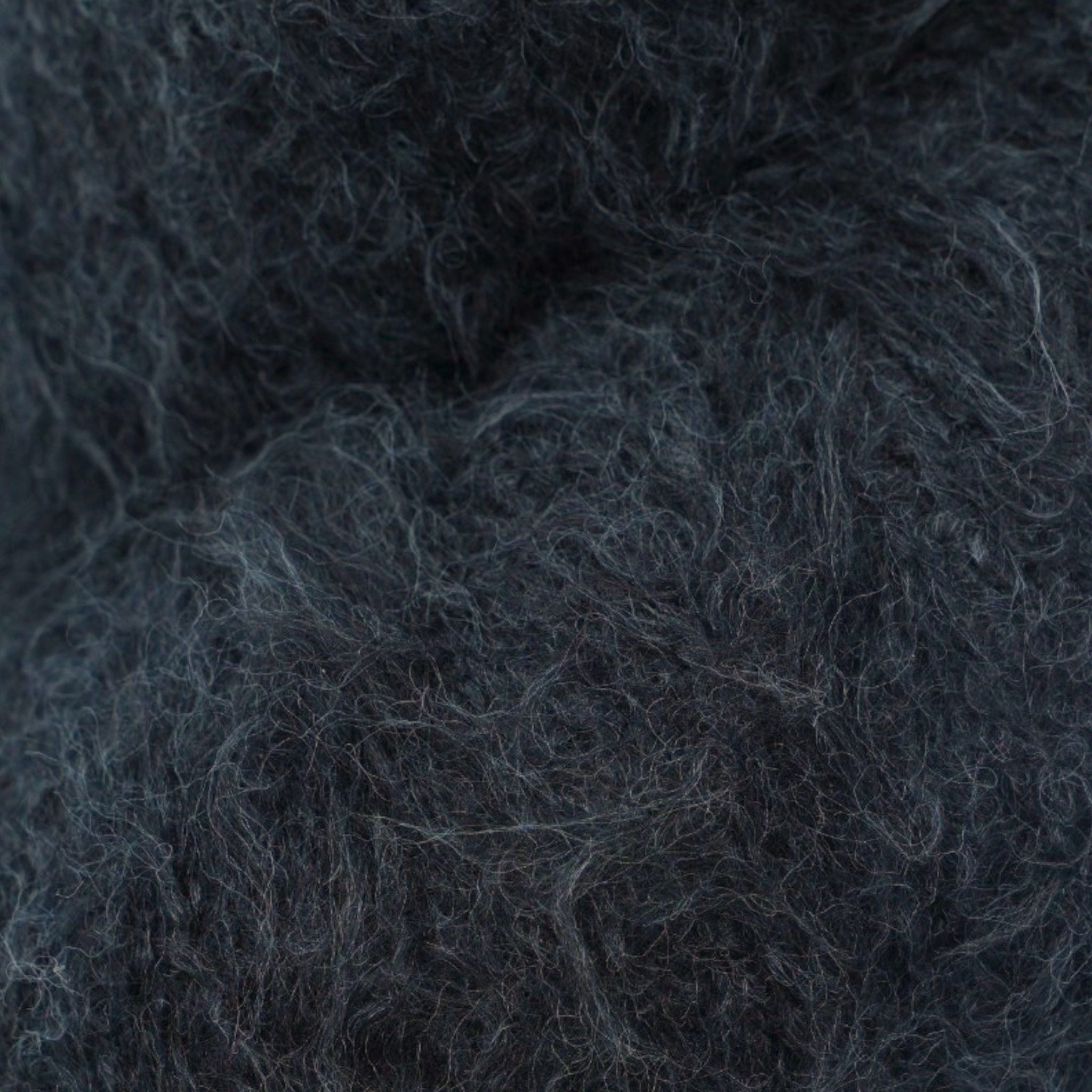A skein of fuzzy lace yarn in a black, displayed against a plain background.