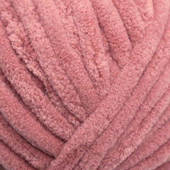 A skein of Okey Dokeys brand Jumbo Velvet Chenille Yarn in pink color.