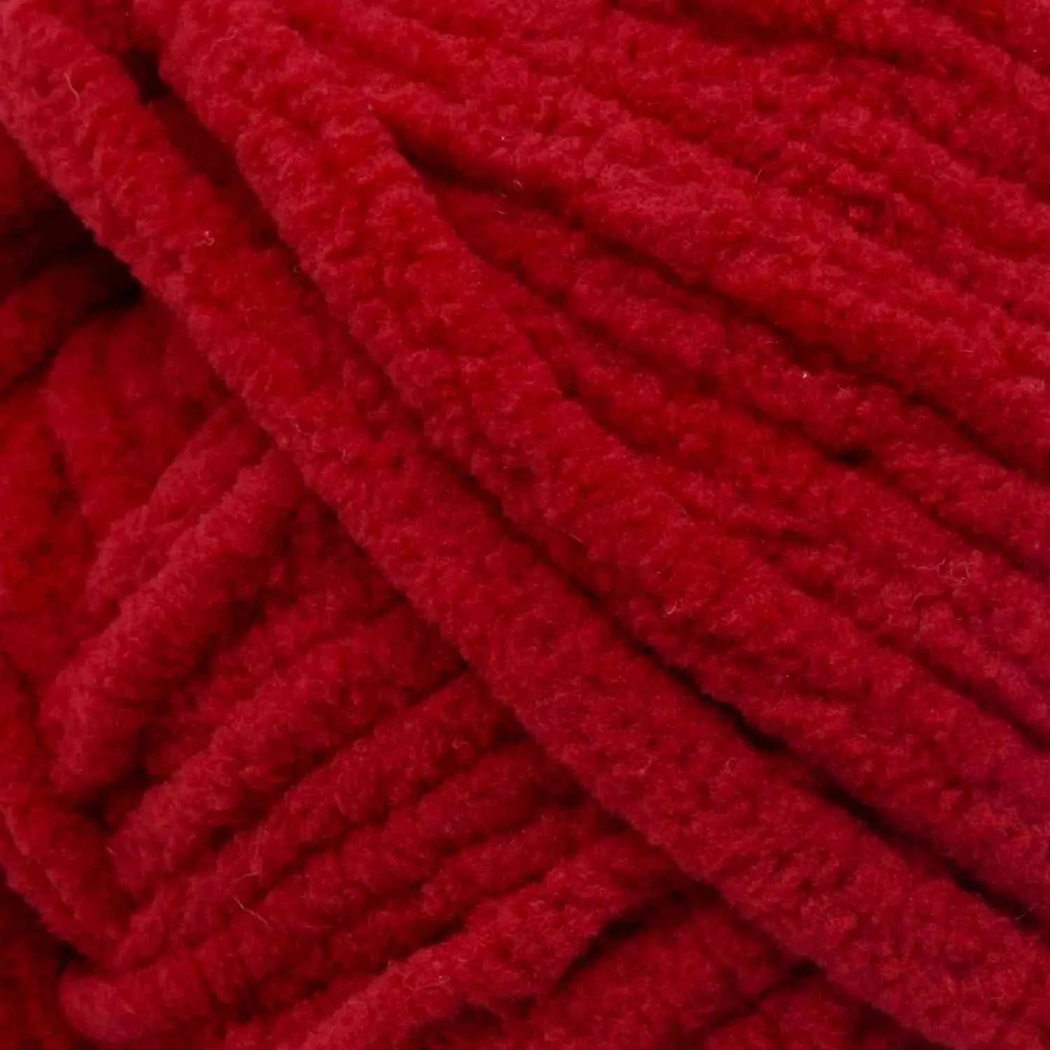 Close-up of red yarn with a textured pattern