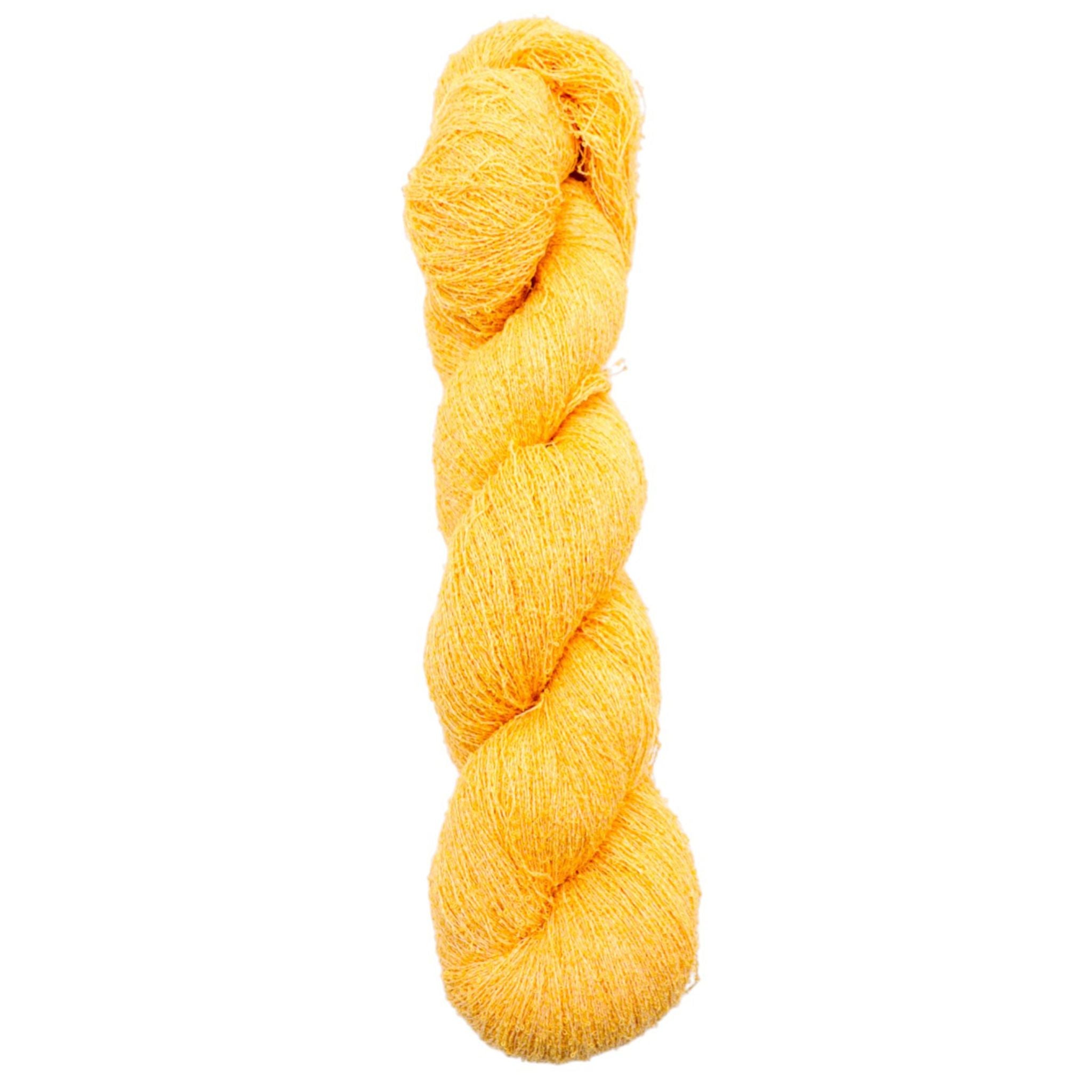 Yellow skein of yarn on a white background