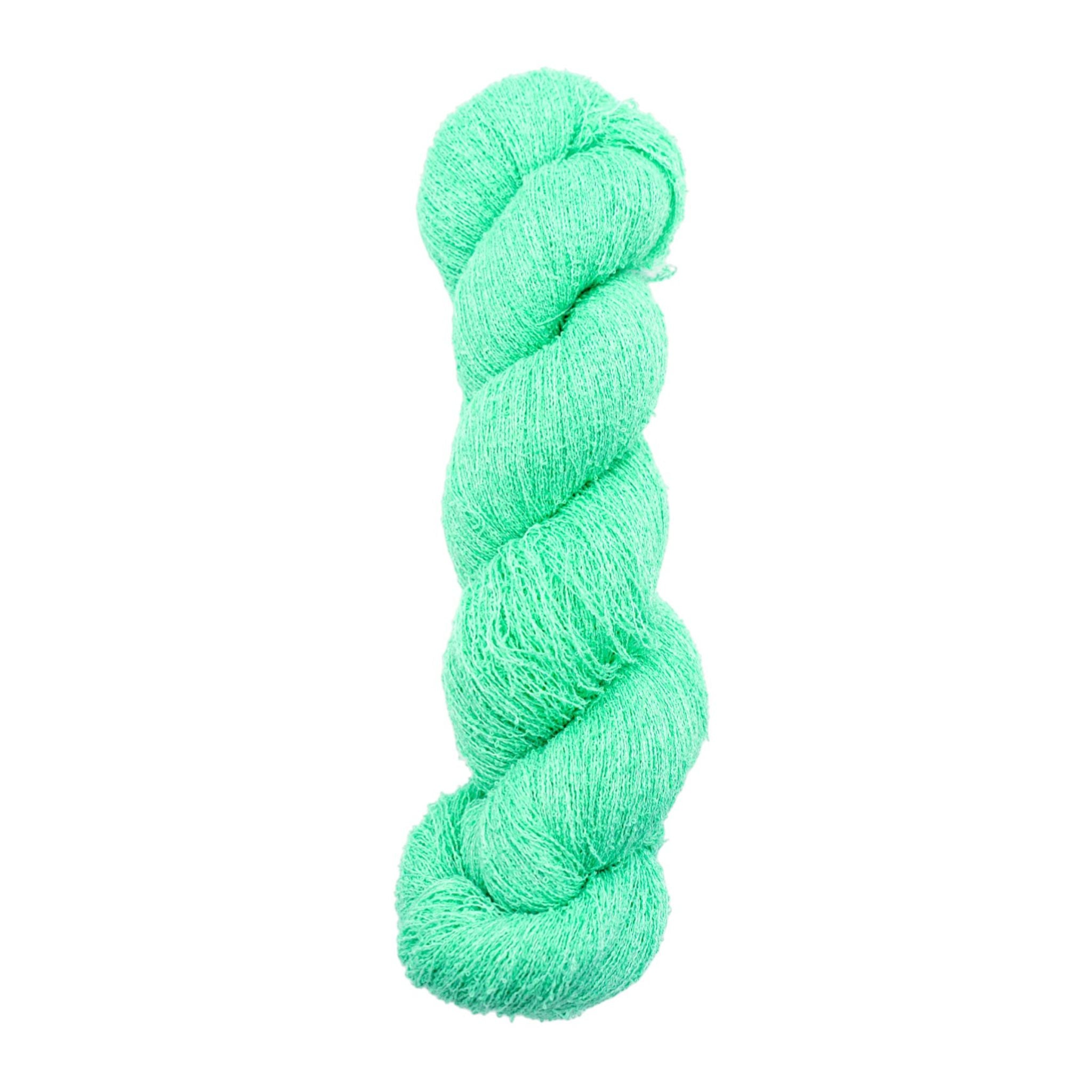 Mint green skein of yarn on a white background