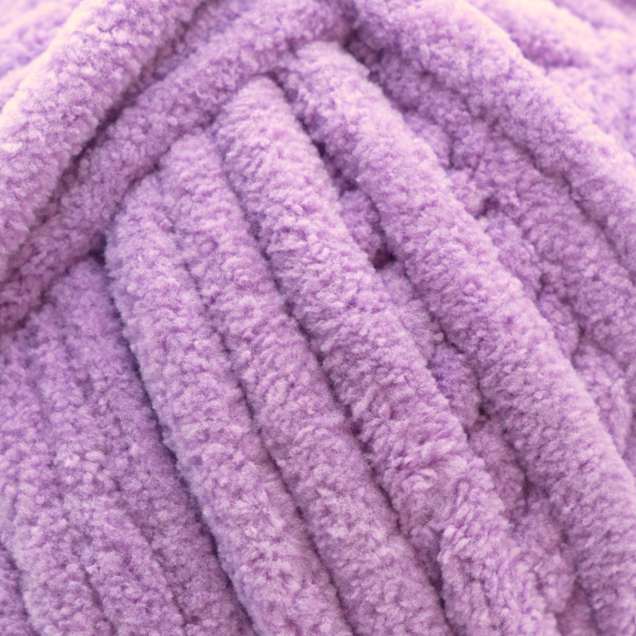 A skein of Okey Dokeys brand Jumbo Velvet Chenille Yarn in pink color.