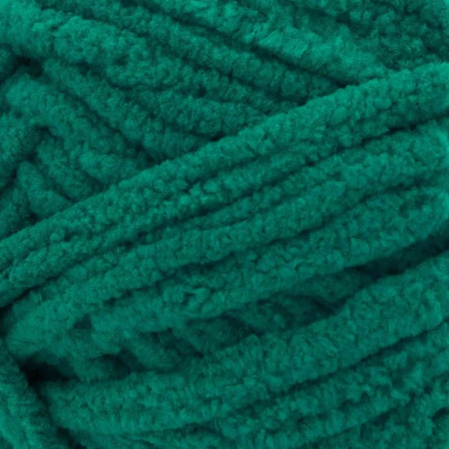 Close-up of teal yarn with a textured surface