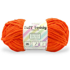 Orange skein of Tuff Teddy yarn with a label on a white background