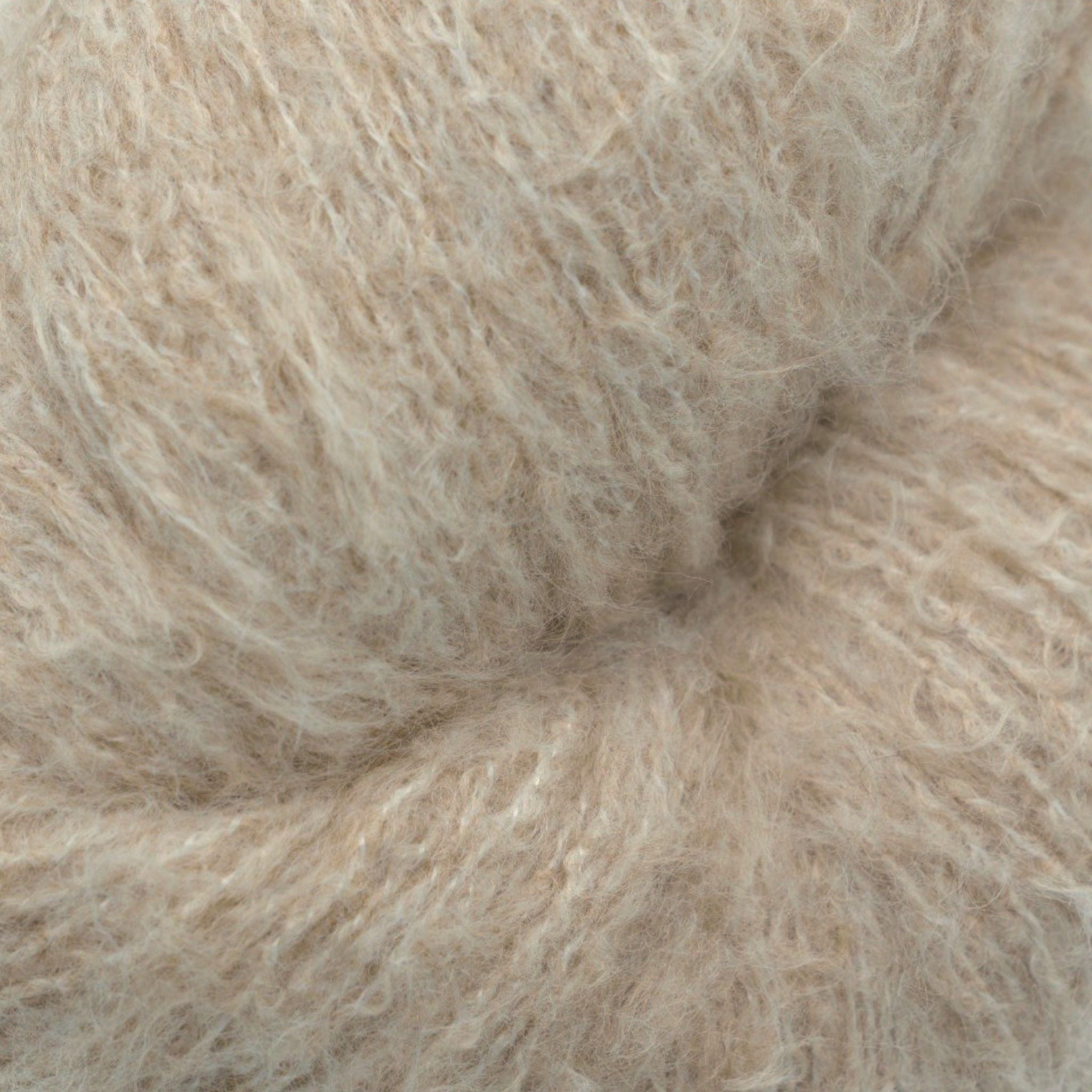 A skein of fuzzy lace yarn in a light brown tan color, displayed against a plain background.