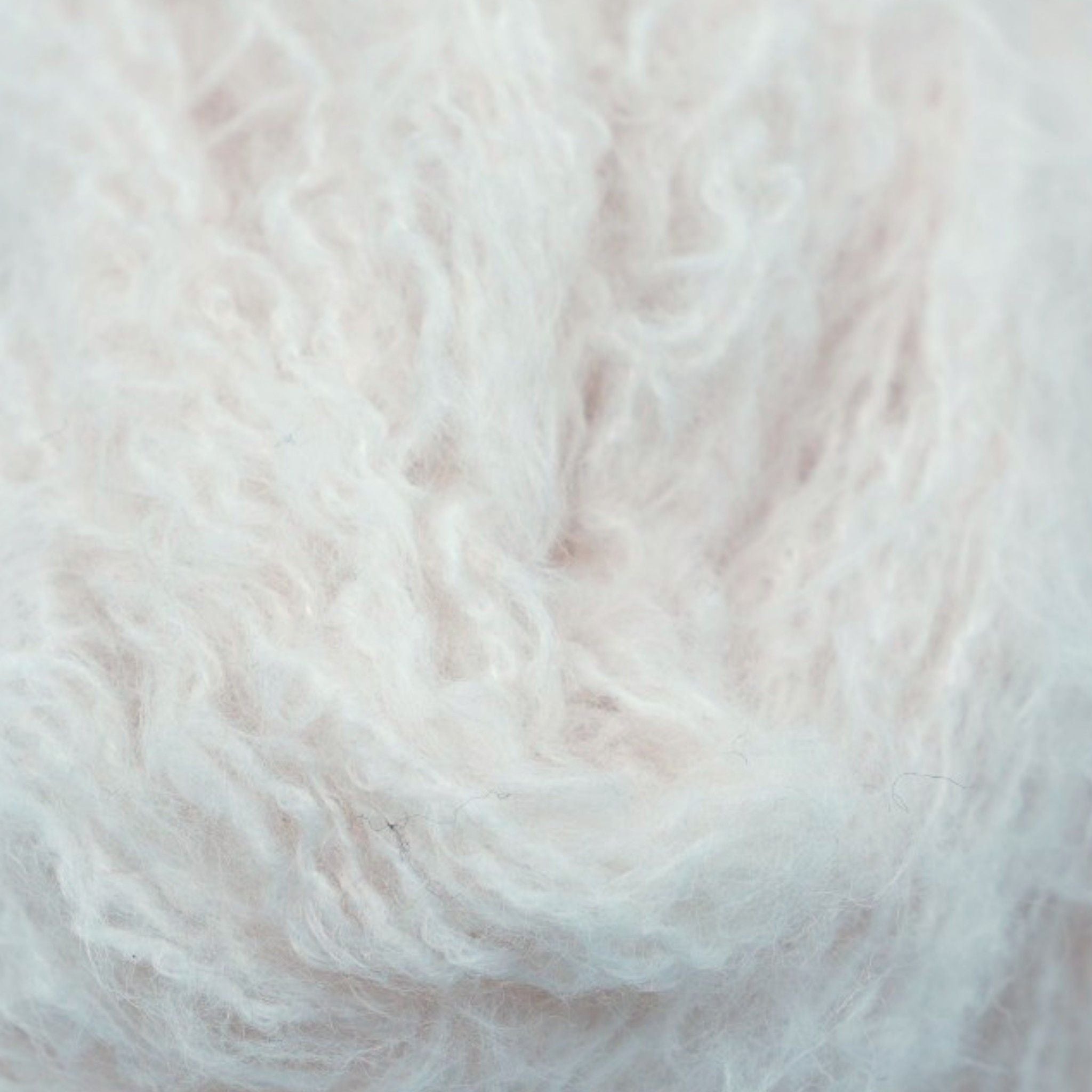 A skein of fine eyelash yarn in a white color.