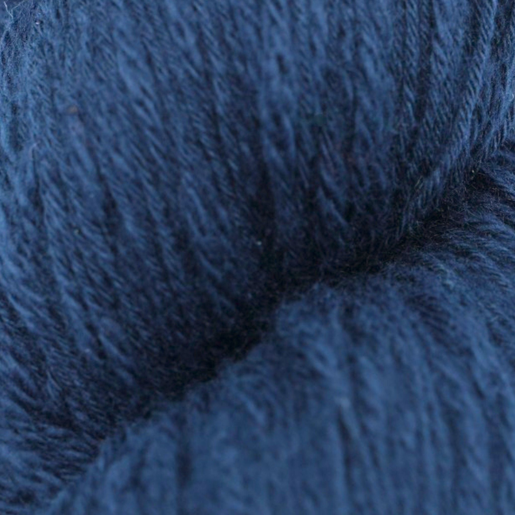 A skein of navy blue cotton slub yarn.