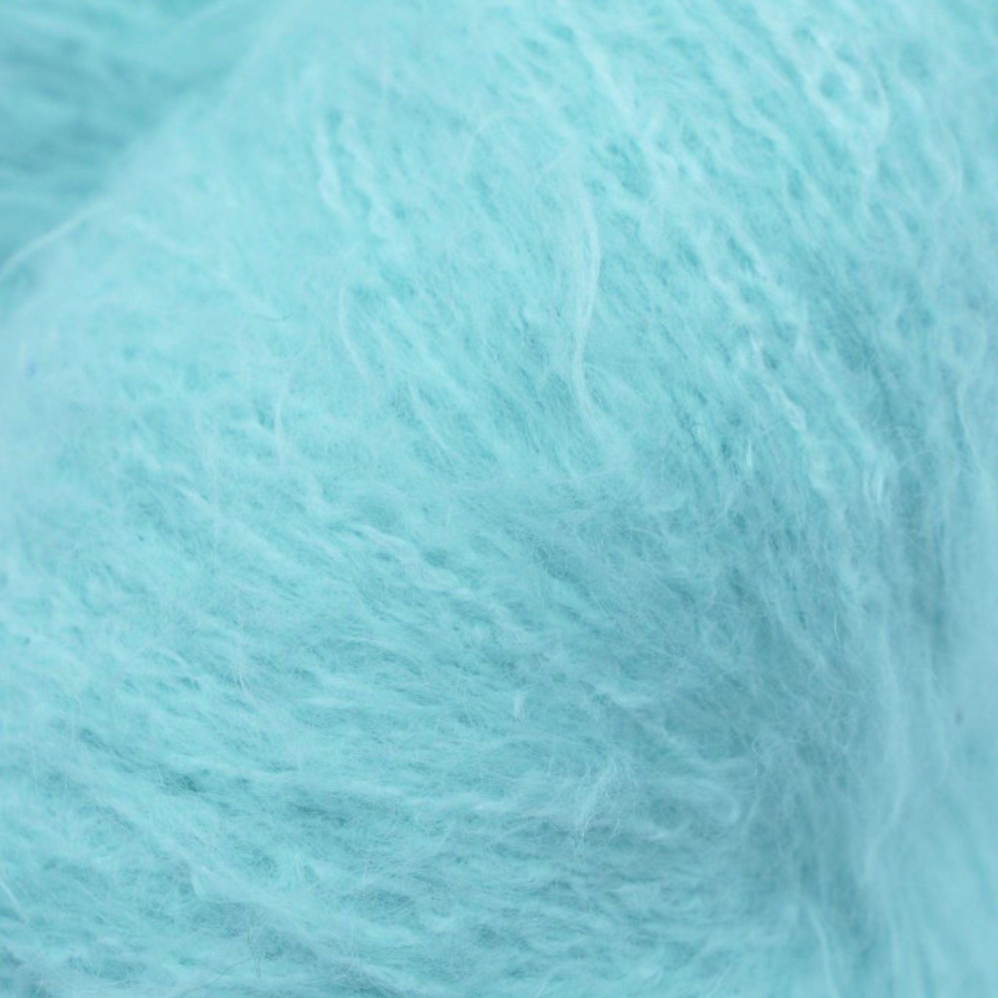 A skein of fuzzy lace yarn in a light blue color, displayed against a plain background.