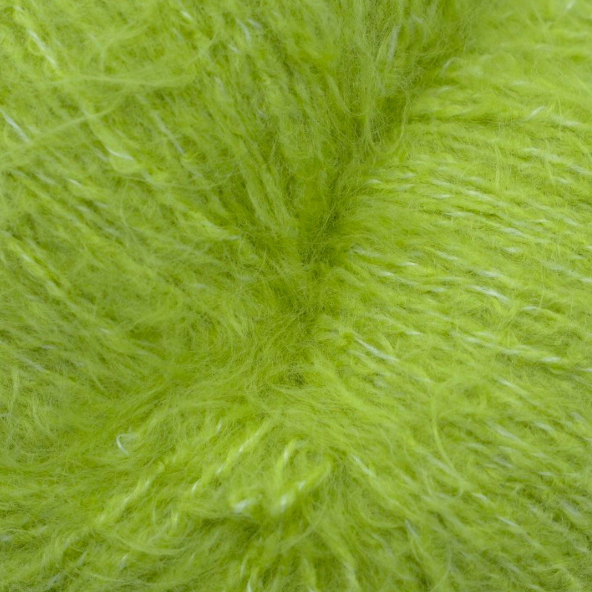 A skein of fuzzy lace yarn in a spring green color, displayed against a plain background.