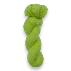 A skein of fuzzy lace yarn in a green color, displayed against a plain background.