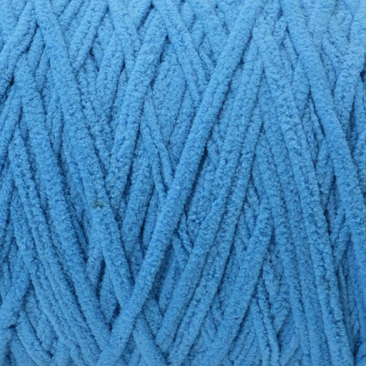 close up of blue Okey Dokey brand chenille yarn with labels showing the yarn type and brand name.
