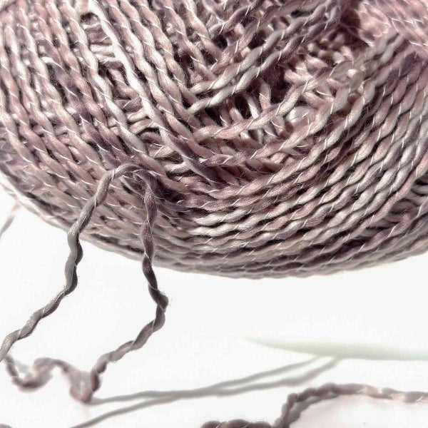 Close-up of a ball of pink yarn on a light background
