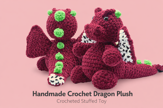 Handmade crochet dragon plush toy on a pink background