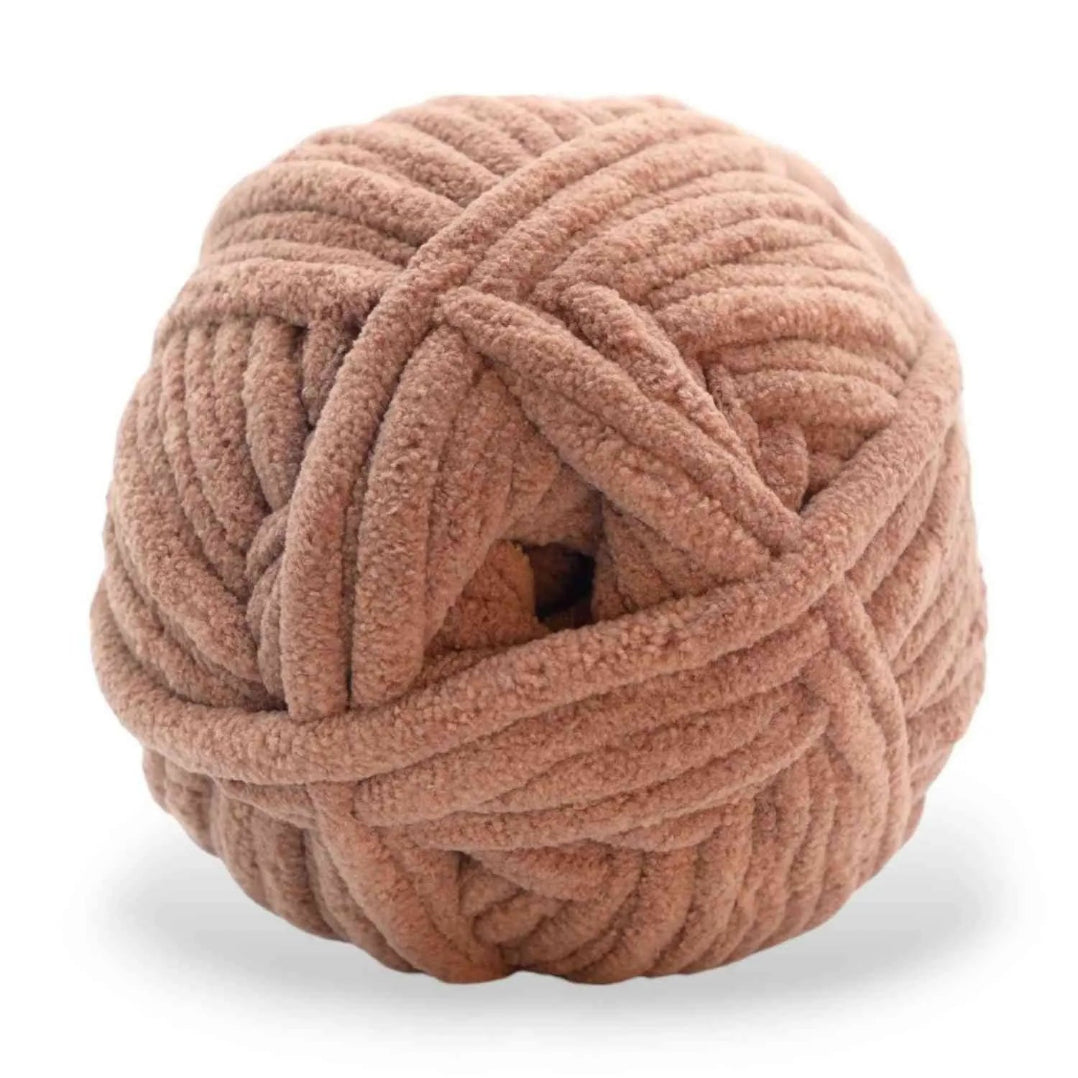 Ball of pink yarn on a white background