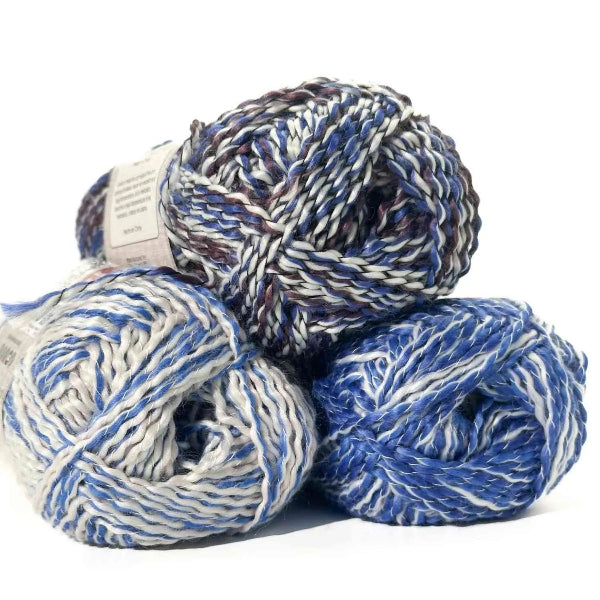 Three skeins of blue and white yarn stacked on a white background