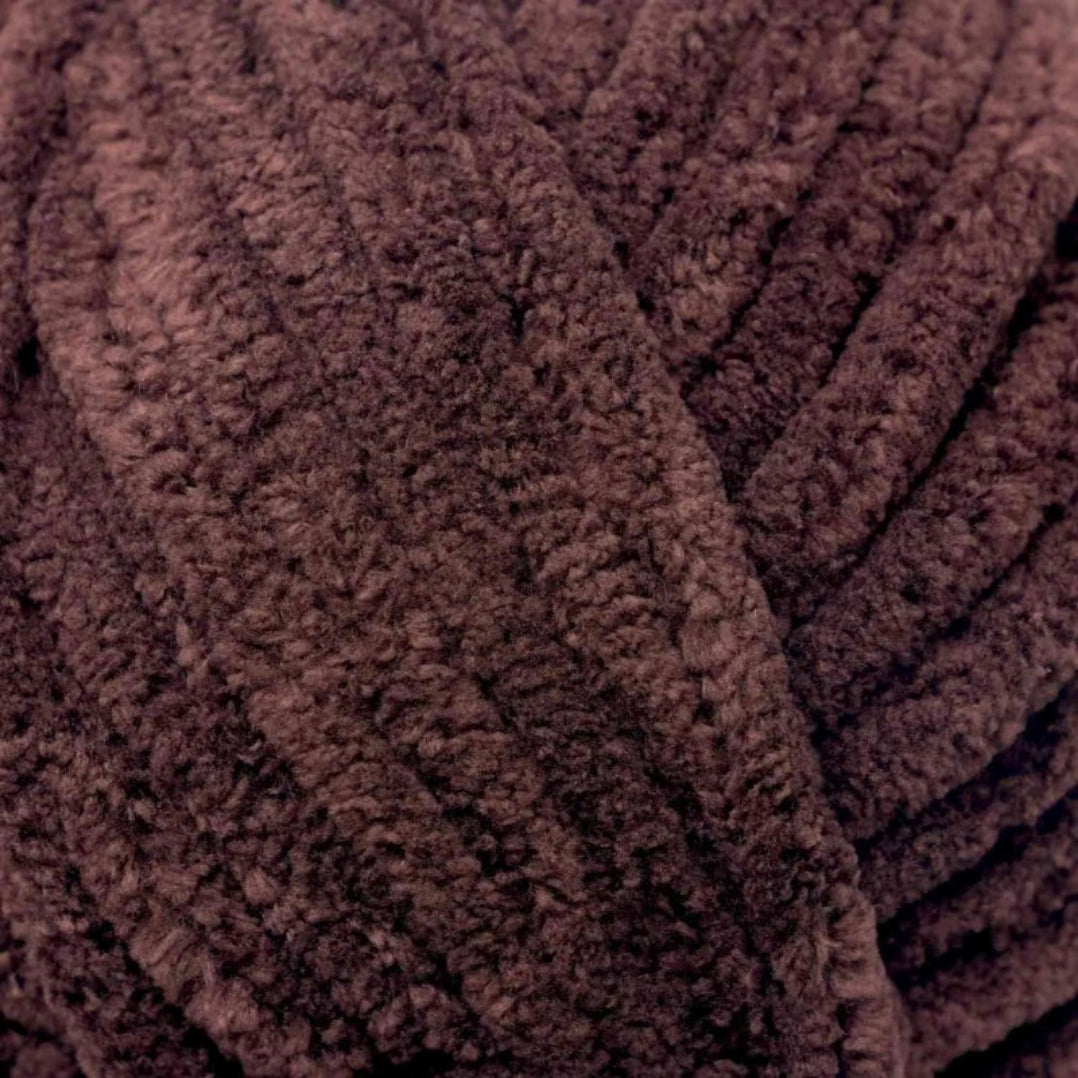 Close-up of a ball of brown yarn with textured surface