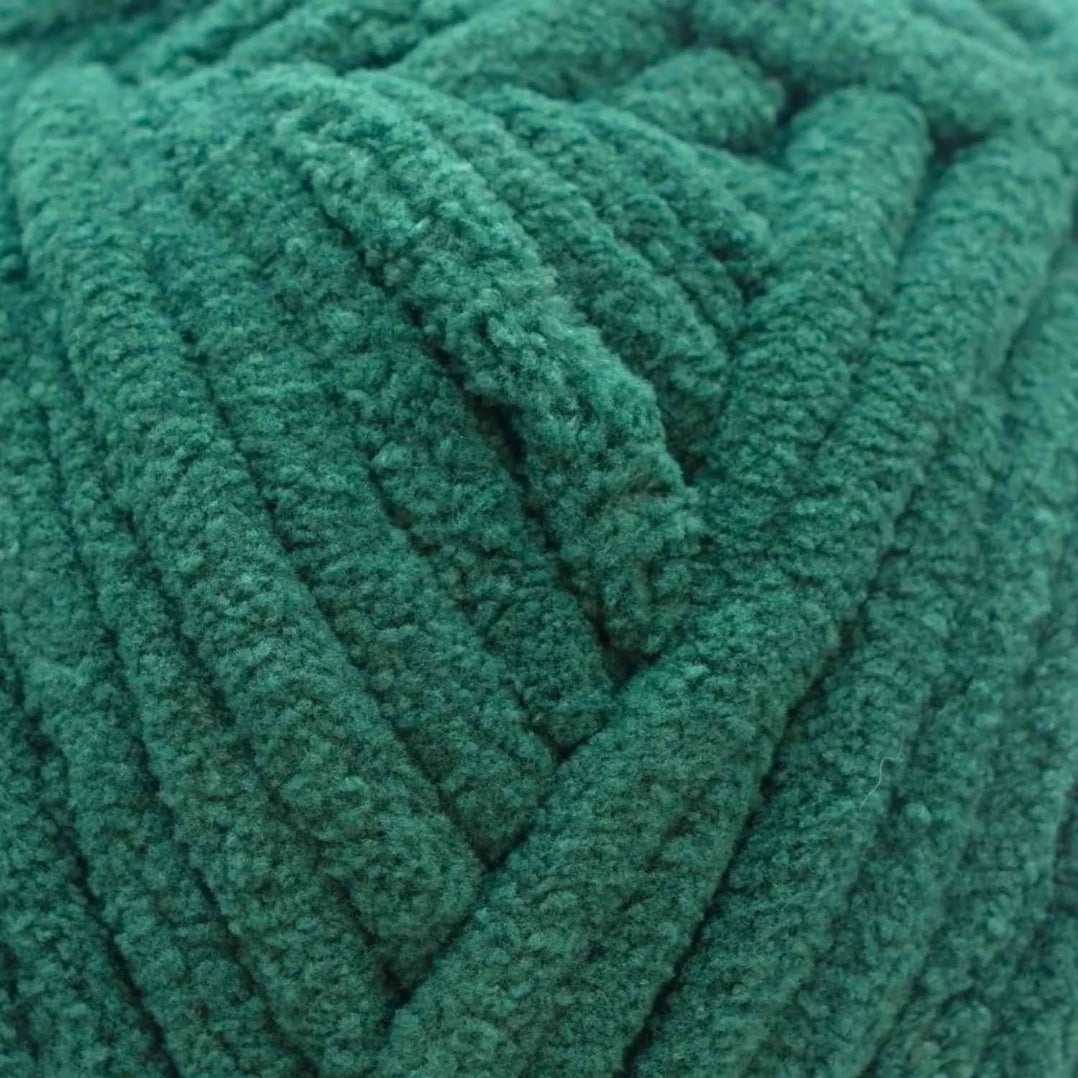Close-up of teal yarn ball with textured surface