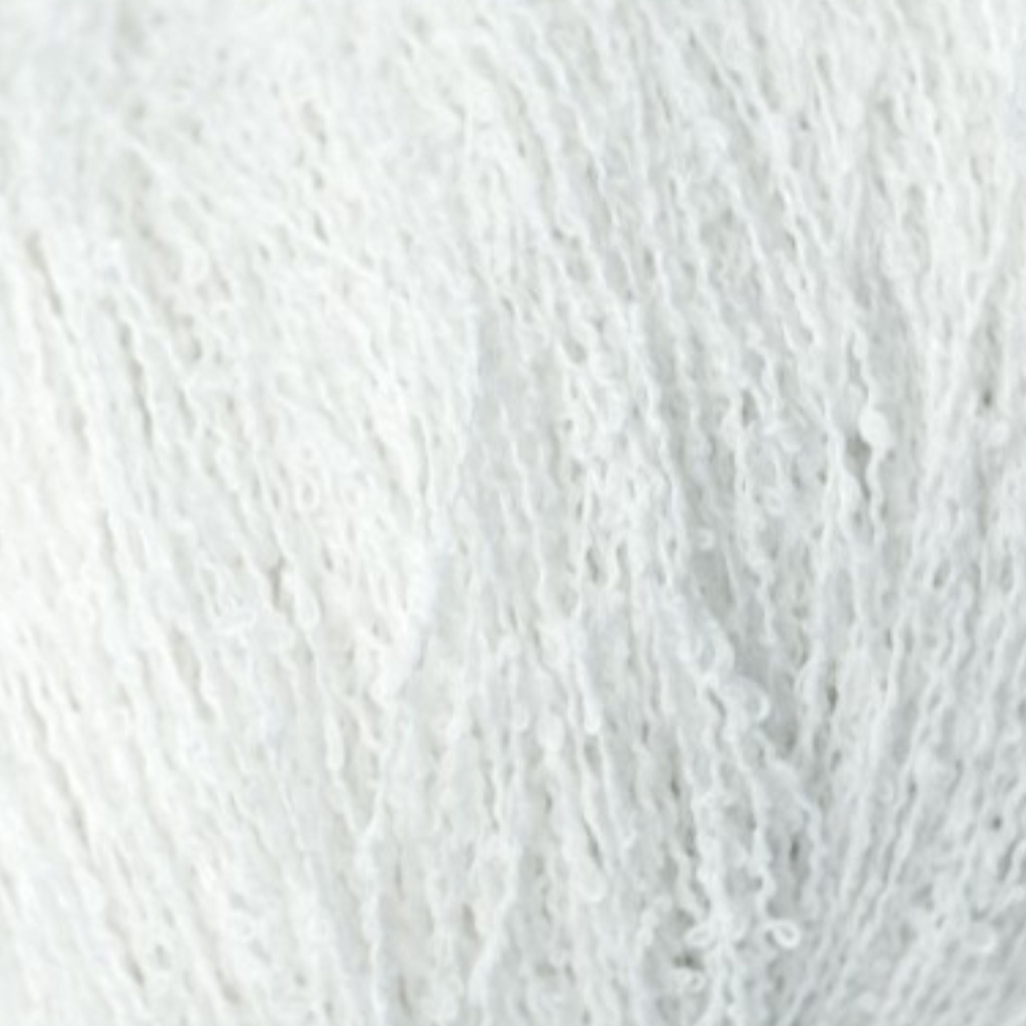 close up of white fluffy boucle yarn 