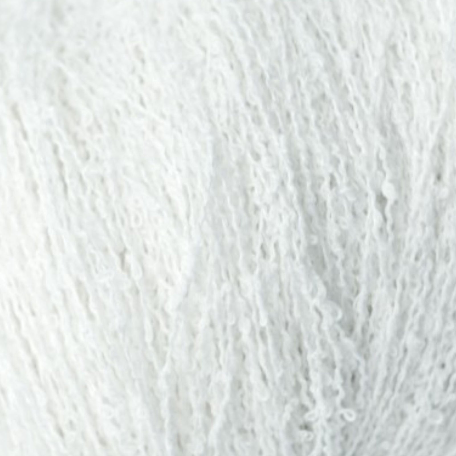 close up of white fluffy boucle yarn 