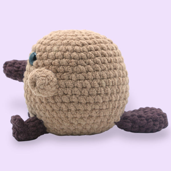 crochet platypus on purple background