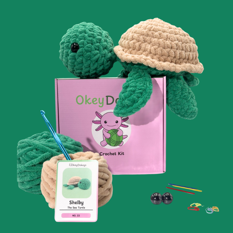 Crochet turtle kit with yarn, hook, and packaging on a green background