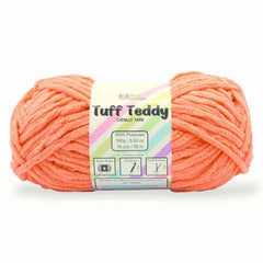 Ball of coral yarn with a label on a white background