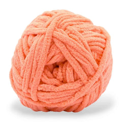 Peach-colored ball of yarn on a white background