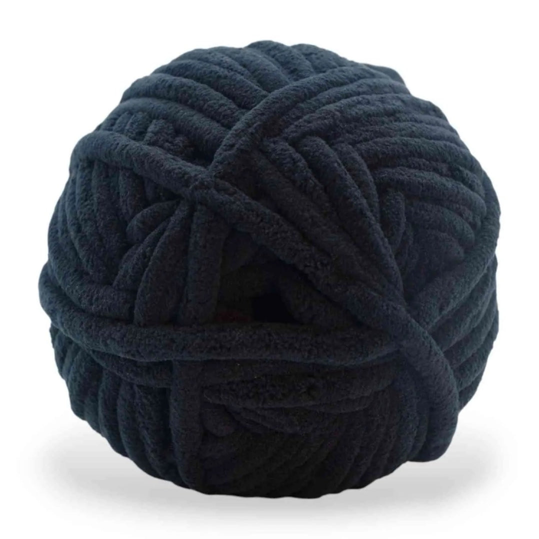 Large ball of dark blue yarn on a white background