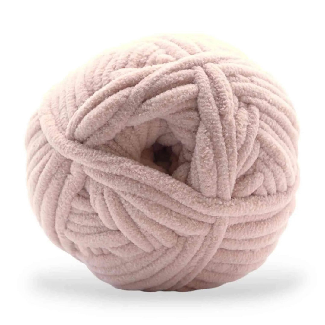 Ball of pink yarn on a white background