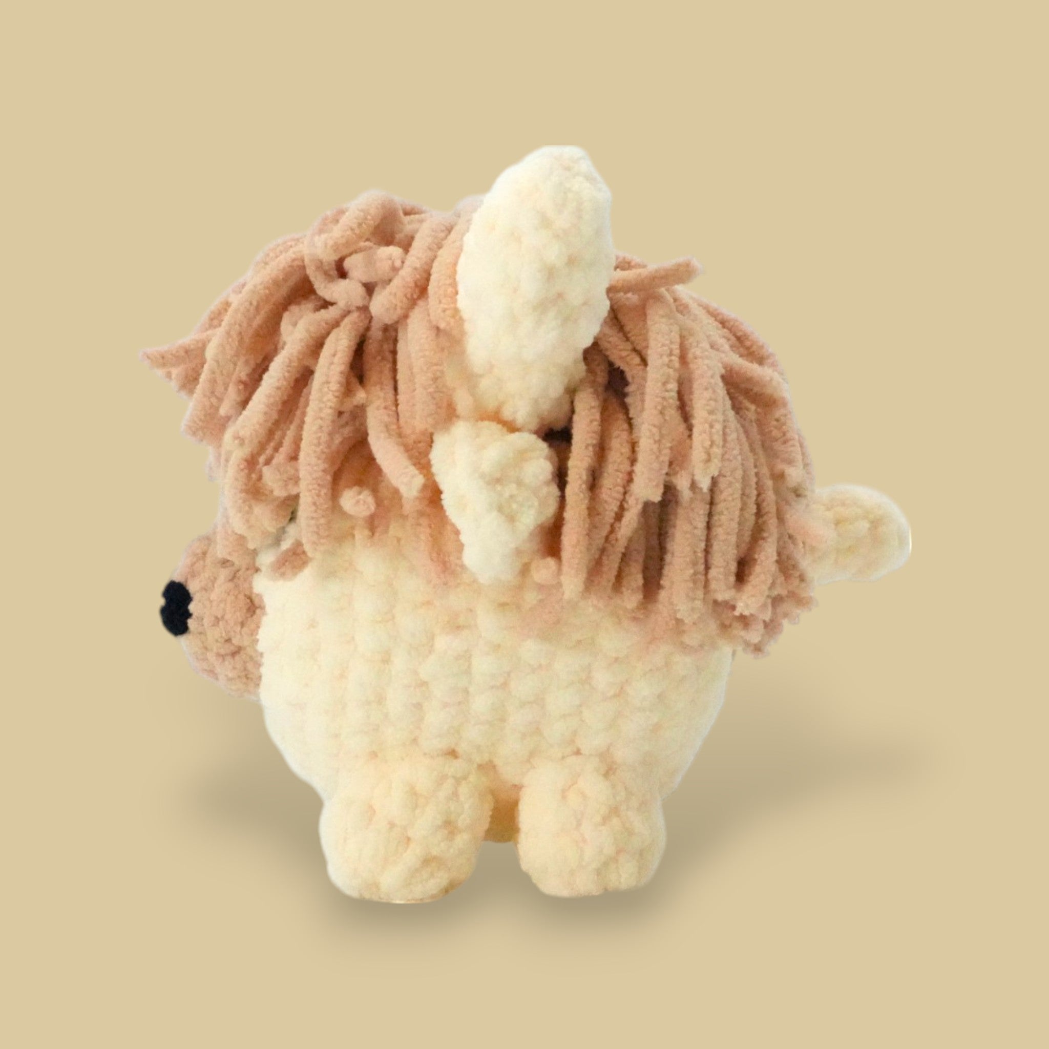 side view of the highland cow crochet kit for beginners and experienced crocheters with soft fuzzy texture