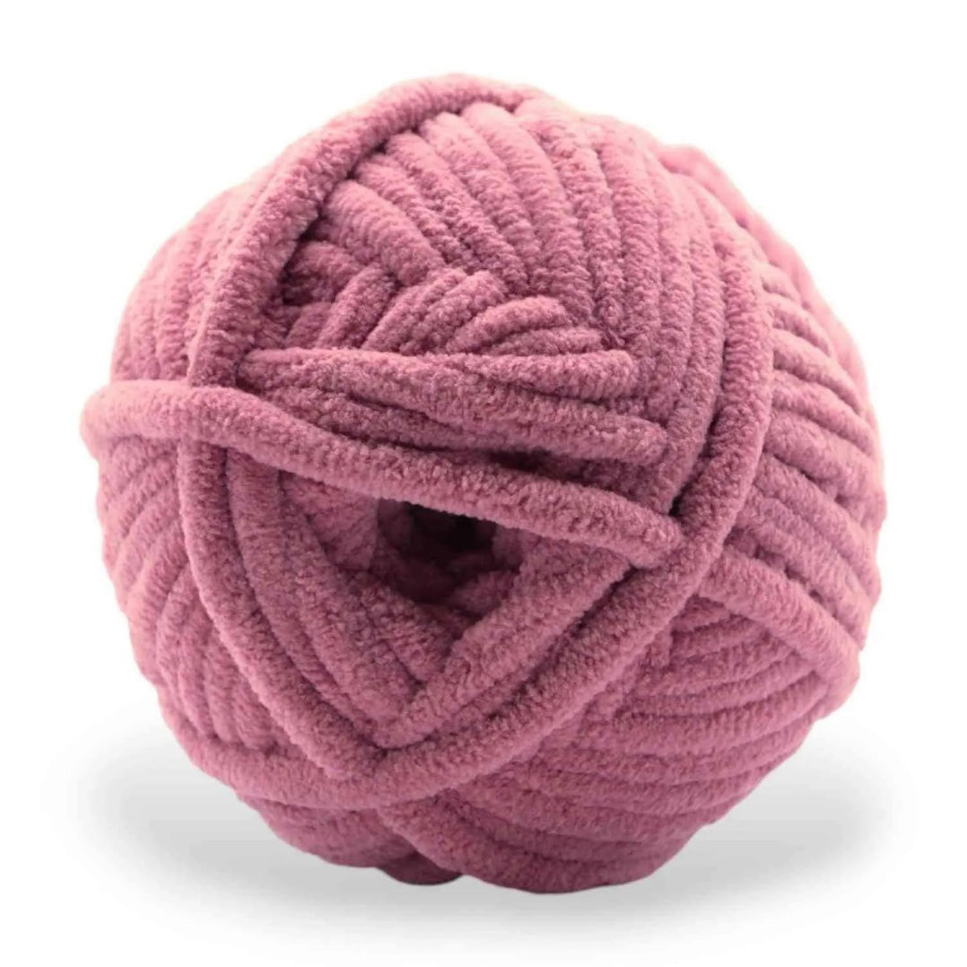 Pink ball of yarn on a white background