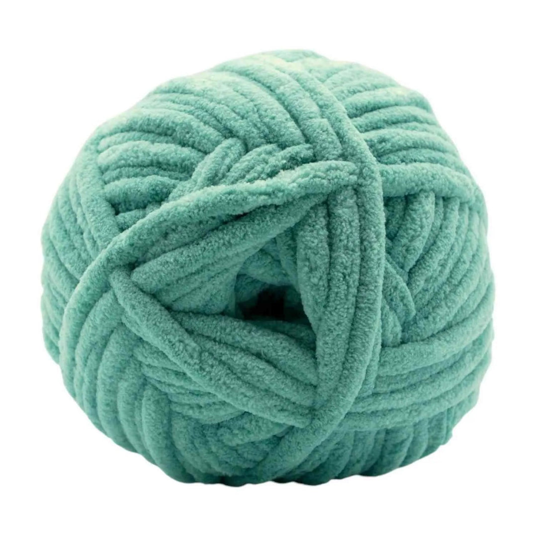Teal skein of yarn on a white background