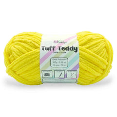 Yellow skein of Tuff Teddy yarn with a label on a white background