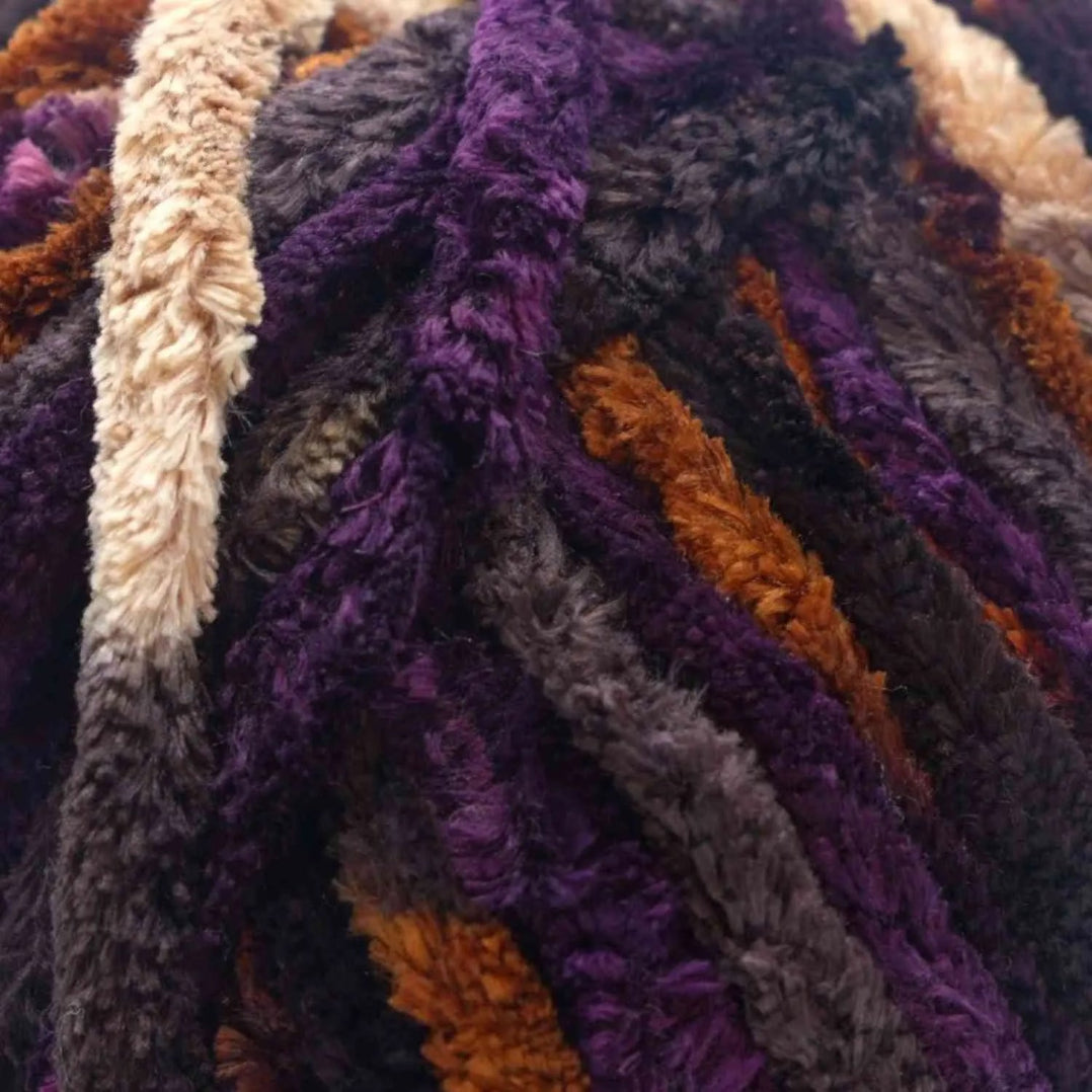 Close-up of textured fabric with purple, brown, and beige colors.