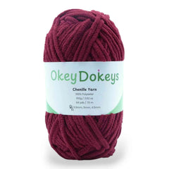 Ball of red yarn with a 'Okey Dokeys' label on a white background