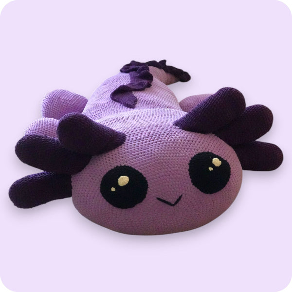 Purple plush toy with black accents on a light purple background