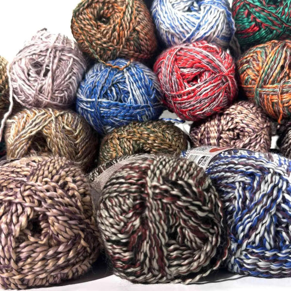 Assorted colorful yarn balls on a white background