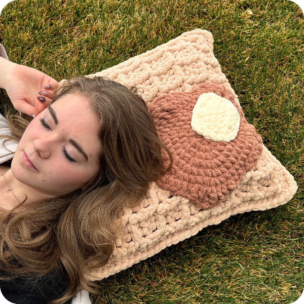 Woman lying on a textured pillow outdoors